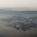 A small boat moving through reed-lined channels in the Danube Delta